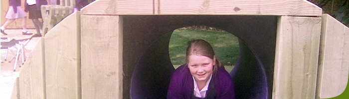 surrey school design project - student crawlig through tunnel 