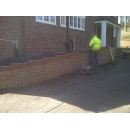 brick retaining wall being built
