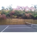 timber retaining wall surrounding tennis court