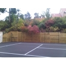timber retaining wall surrounding tennis court