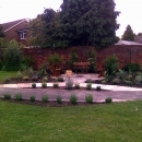 flowerbeds and new plants with circular seating area