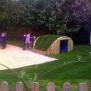 turf covered wooden play tunnel
