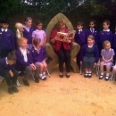 teacher reading to young students in new outdoor area