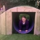 studen using new wooden tunnel in play area