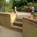 textured stone and brick wall with steps