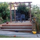 pergola and seating area at the top of steps in garden